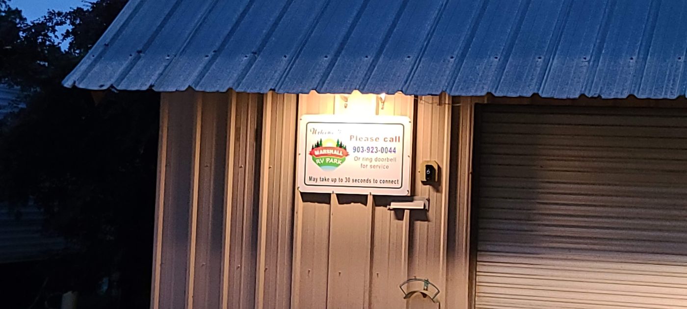 The lit Marshall RV Park sign at dusk